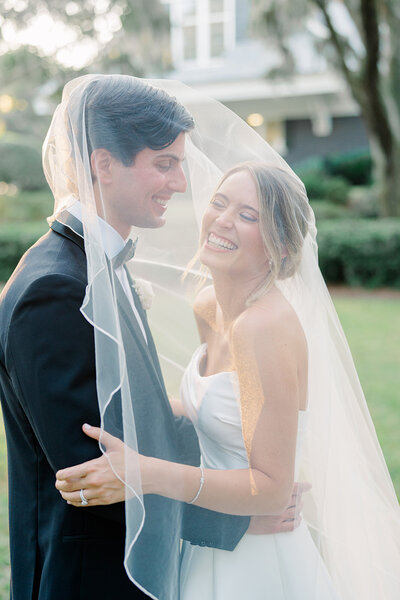 happy couple at the river course, Charleston Bride Weddings. Charleston destination wedding photographer.