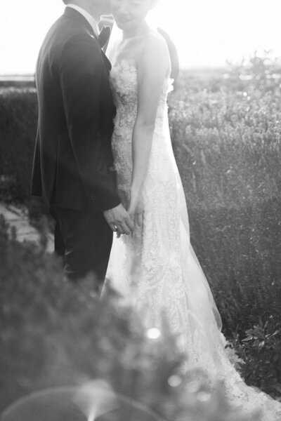 Wedding holding hands in their la Foce wedding in Tuscany, captured by Italy photographer Andreas K. Georgiou