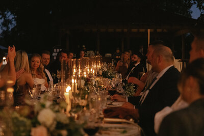 Candle-lit dinner during luxury wedding at Charles Krug Winery in St. Helena, CA, photographed by a Denver-based wedding photographer. 