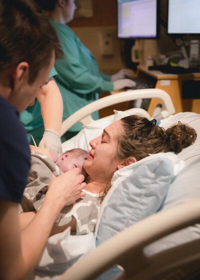 A new mother cries as she greets her baby for the first time. Diane Owen Photography.
