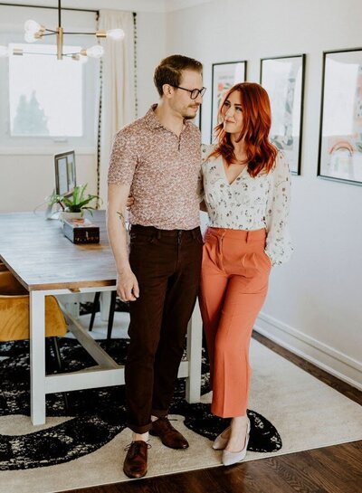 Stylish photo of Brittany Frid and Production Manager Lee Large standing together in their Ottawa studio, arms around each other, showcasing their passion for wedding florals, decor, and stationery services.