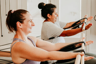 3 people stretching Reformer pilates sandgate