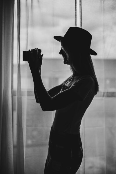 Silhouette of Stacy Lynn holding her camera