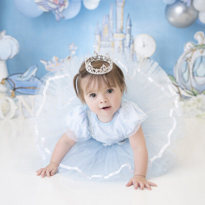 One year old in princess dress studio portrait