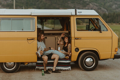 couple sitting in yellow van