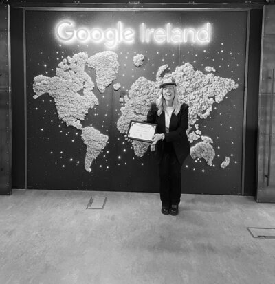 Woman holding a certificate in front of Google Ireland sign