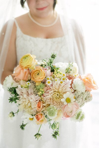 A stylish bride holding her bouquet in a timeless, editorial-inspired portrait. Captured by Alexia Rodriquez, a luxury wedding photographer based in the Midwest and available worldwide.