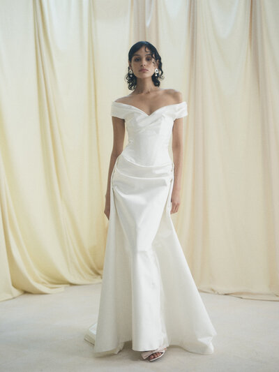 black and white image bride wearing strapless satin wedding dress with long train