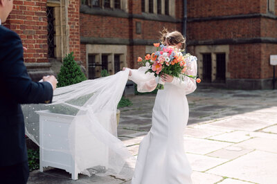 Bride and groom sharing a joyful moment in their suite at a Williamsburg, Brooklyn hotel during their New York City wedding.