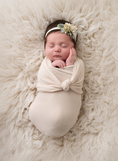 Wrapped Newborn in Cream Color Fur