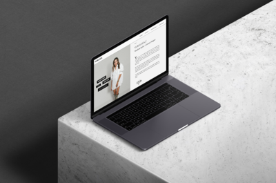 An apple macbook pro on marble showing the website of wardrobe stylist yuri loza.