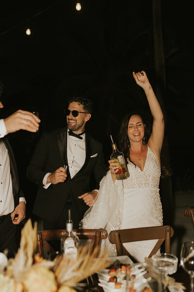 bride and groom celebrating at night
