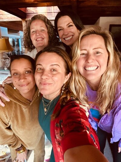 Katie, spiritual entrepreneur and corporate coach, with friends, radiating joy and connection.