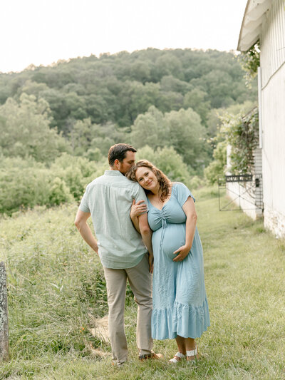 a portrait of a couple in a beautiful field during a maternity session