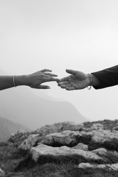 man and woman reaching out to touch each other