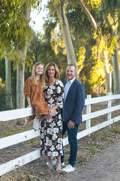 Family smiling at Ernie Howlett Park during fall portrait session