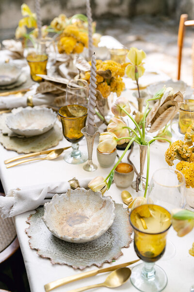Stunning wedding reception tablescape with yellow floral centerpieces