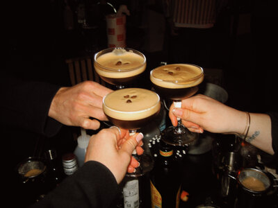 Group raising espresso martinis in celebration — reflecting the joyful, elevated lifestyle of stress-free travel.