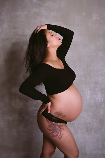 pregnant woman with hand in her hair for maternity boudoir