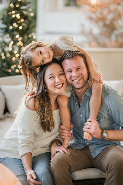 Adorable family photography by Cassey Golden of a young boy and girl hugging and making adorable faces while being held by mom and dad.