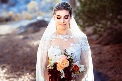 Bridal portrait with veil and flowers amongst the mountains in Mammoth California