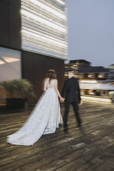 East Coast Wedding photographer photographs newly weds during blue hour on the Halifax Waterfront. 