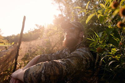 A man walking with a backpack and gear deer hunting during early bow season in southern wisconsin