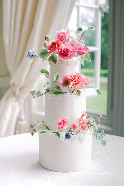Spring garden wedding cake with vibrant sugar flower halos for each tier