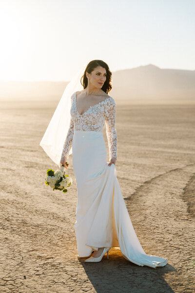 Bride at the boulder city dry lake bed in nevada during sunset