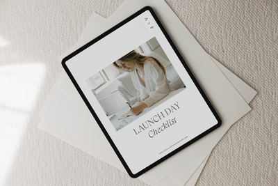 An iPad on linen books.
