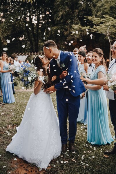 Newlywed couple kissing after wedding ceremony