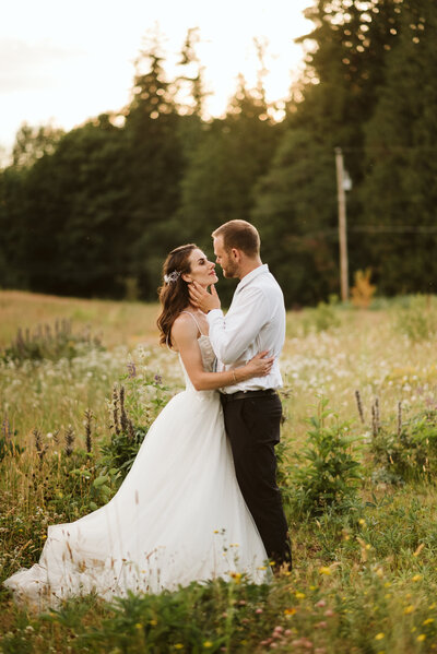 A couple posing in a field of wild flowers in Maple Ridge for their wedding photos