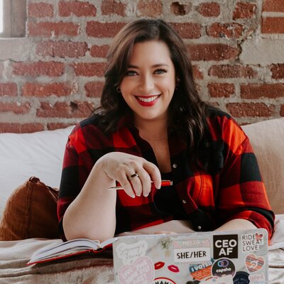 Renee Dalo smiles while working on her laptop
