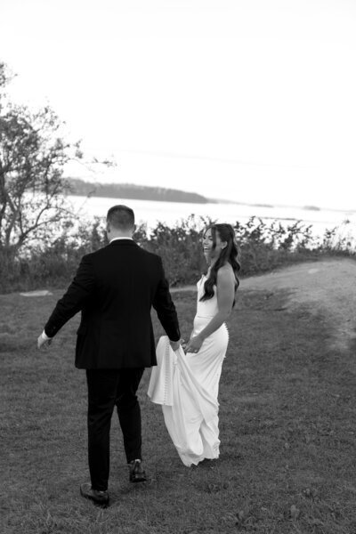 Groom holding bride's dress taken by wedding photographers jacksonville fl