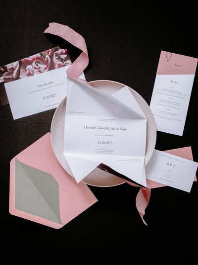 Pink origami wedding invitation with pink and green envelope