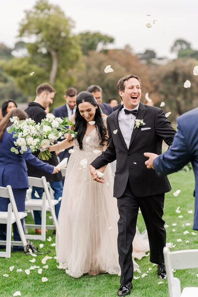 Bride and Groom walk hand in hand smiling down the aisle after their ceremony. Taken by Los Angeles wedding photographer Rachel Paige Photography