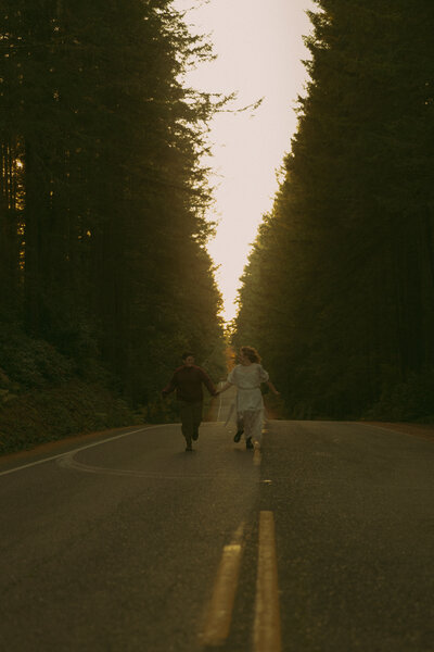 Man and woman romantically spin around, laughing in the middle of a  flowery field