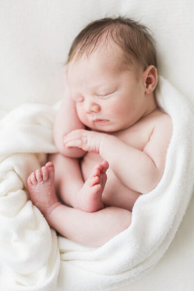 newborn wrapped in white blanket
