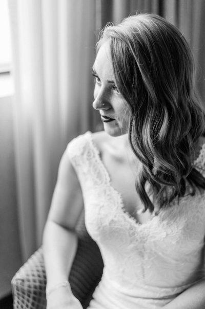 bride sitting on couch looking away and laughing