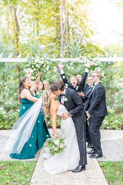 Wedding party throwing rose petals over the bride and groom by Sherr Weddings in San Diego, California.