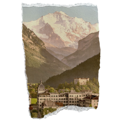 Aged photo of mountains, trees, and a town in the valley with ripped edges 