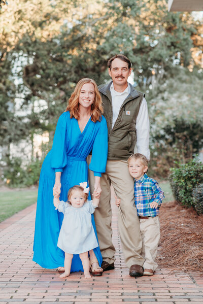 Mom, Dad, and Daughter posing for a sunset family session in Brentwood, CA