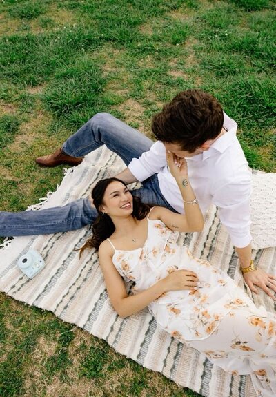 couple embraces on picnic blanket in atlanta park