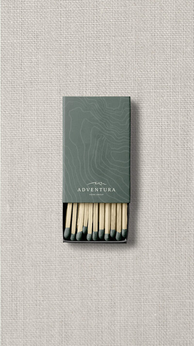 Green matchbook with topography pattern printed on it