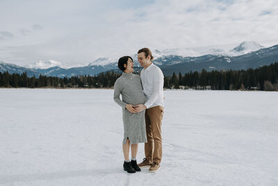 Newly engaged couple cuddle and laugh after Horseshoe Bay proposal at sunset