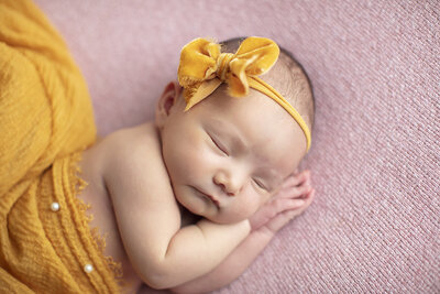 Newborn boy on vintage bed.