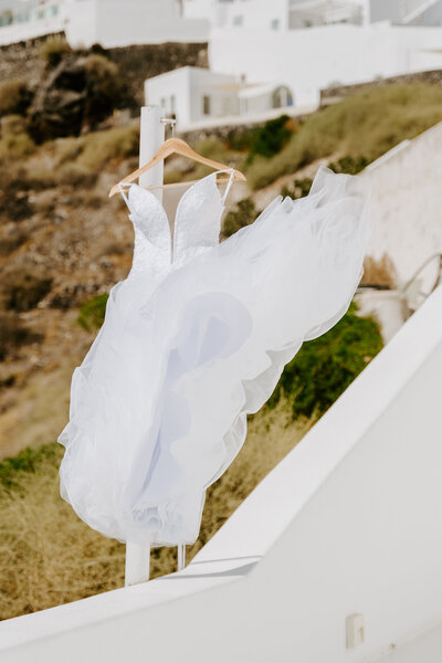 Bridal dress blowing through the wind in Santorini