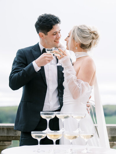 Bride and groom celebrating with a champagne tower at their Richmond wedding reception, captured by Kaytlyn Rei Photography.
