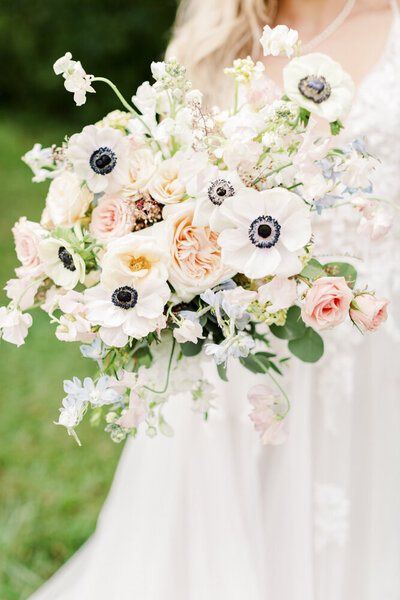 close up of a woman holding a flower bouquet