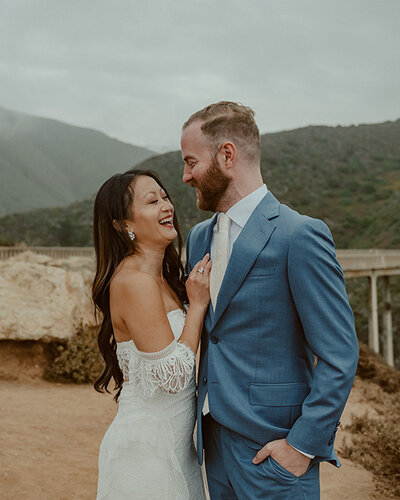 bride and groom embrace tightly with sunset in the background